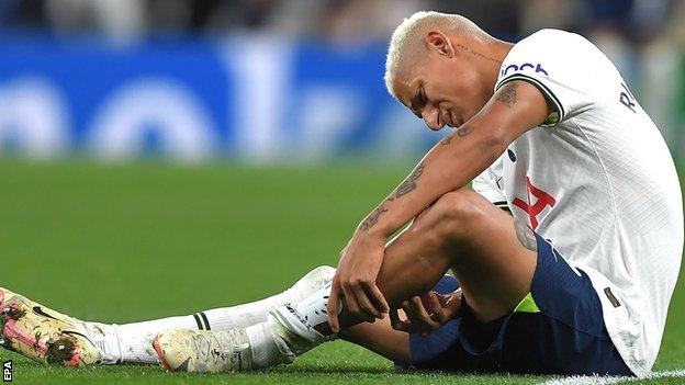 Richarlison winces with an injury