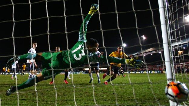 Newport forward Padraig Amond heads the ball past Spurs keeper Michel Vorm to send Rodney Parade into raptures