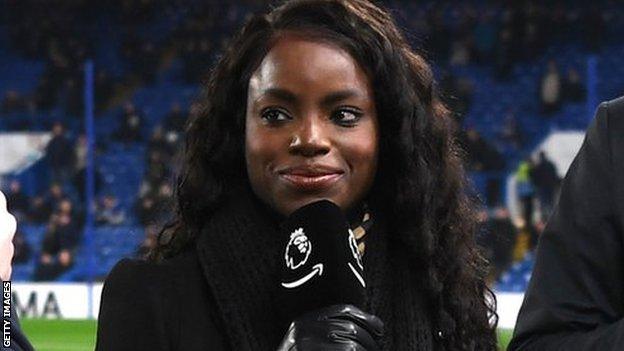 Eniola Aluko smiling and holding a microphone while working as a pitchside TV pundit