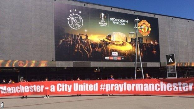 Manchester United fans with a banner outside the Friends Arena in Stockholm