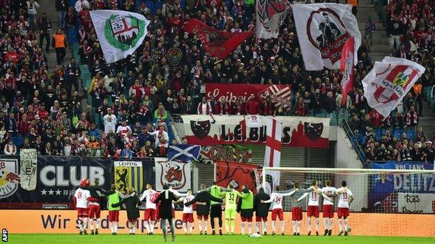 RB Leipzig players celebrate a win with their fans