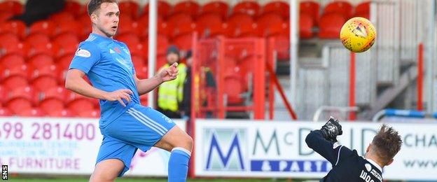 Greg Stewart watches as his shot beats Gary Woods to draw Aberdeen level in the first half