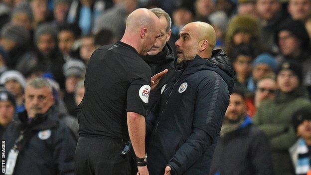 Pep Guardiola is spoken to by referee Anthony Taylor