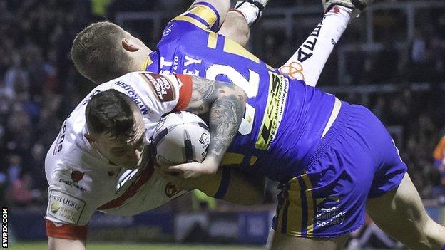 Leeds' Ash Handley upends St Helens' Matty Dawson