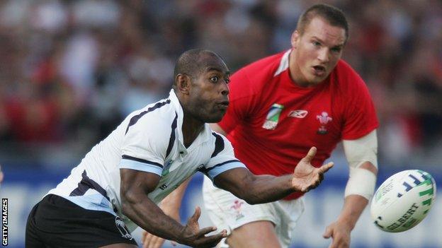 Mosese Rauluni of Fiji passes the ball as Gethin Jenkins of Wales closes in during the Rugby World Cup 2007