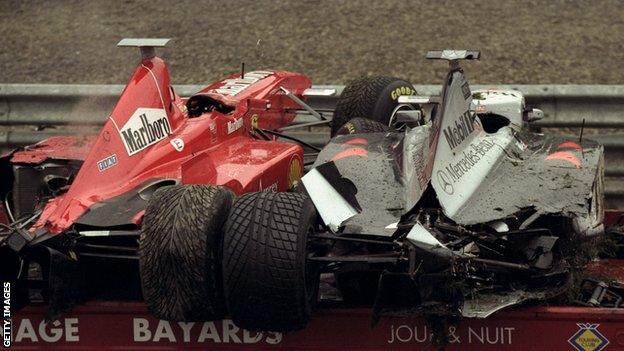 Eddie Irvine and David Coulthard's cars are loaded onto the recovery van