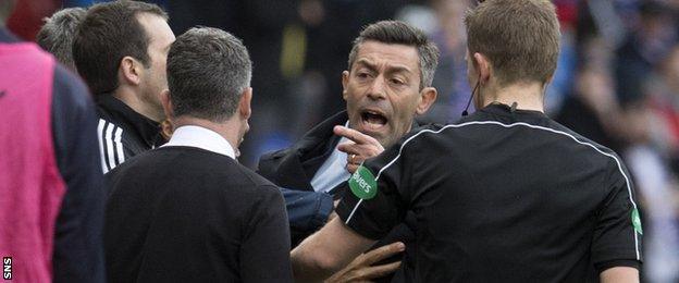 Pedro Caixinha points at Motherwell boss Stephen Robinson on the touchline