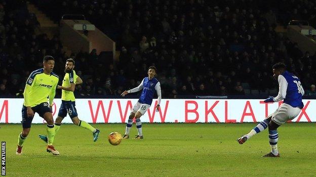 Lucas Joao leans back and sweeps in Sheffield Wednesday's first goal against Derby