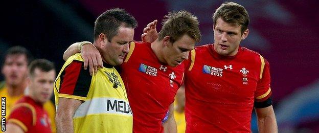 Liam Williams is helped off the field against Australia