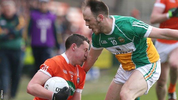 Armagh defender Charlie Vernon feels the impact of this challenge from Offaly's Graham Guilfoyle