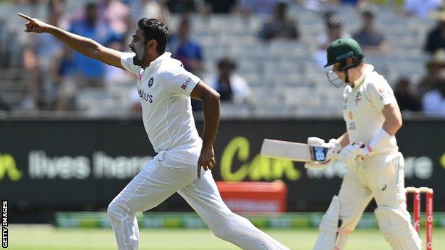 India spinner Ravichandran Ashwin (left) runs off in celebration after dismissing Australia batsman Steve Smith on day one of the second Test