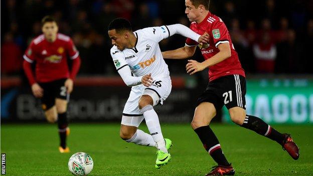 Swansea's Martin Olsson challenges Ander Herrera of Manchester United