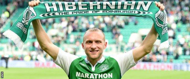 Dylan McGeouch with a Hibernian scarf after his side's draw with Rangers