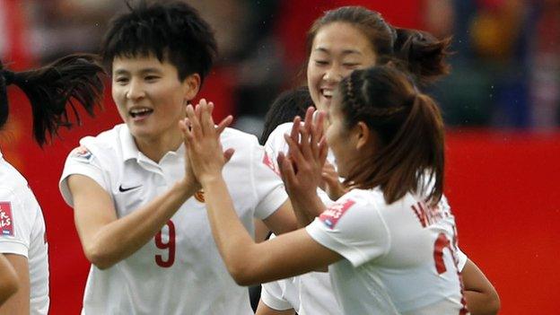 Wang Shanshan (left) celebrates scoring for China against Cameroon