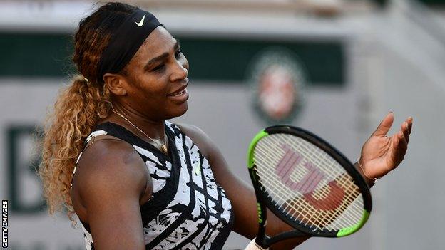 Serena Williams holds her hands up in frustration