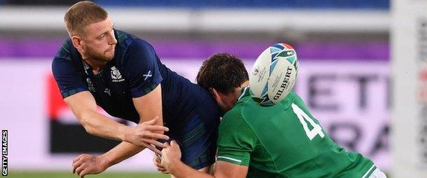 Finn Russell off-loads for Scotland against Ireland