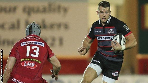 Jason Harries of Edinburgh takes on Scarlets defender Jonathan Davies