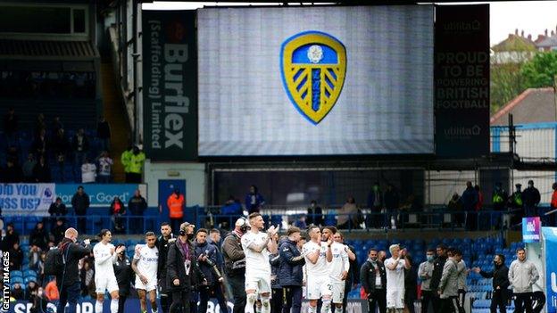 Leeds players clap supporters during an end of season lap of the pitch