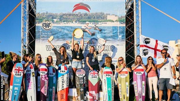 Ellie Aldridge celebrates with fellow kitefoilers