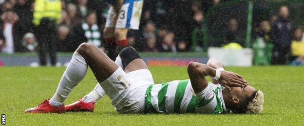 Scott Sinclair lies on the ground with his hands to his head after missing a chance against Rangers