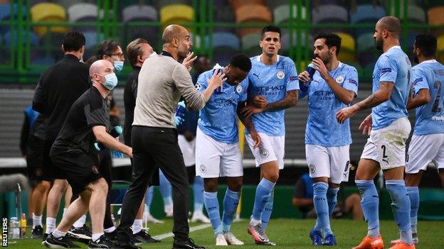 Manchester City coach Pep Guardiola (second left) and his players