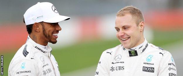 Lewis Hamilton of Great Britain and Mercedes GP shares a joke with Valtteri Bottas of Finland and Mercedes GP during the launch of the Mercedes formula one team's 2017 car