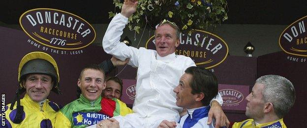 Pat Eddery is hoisted aloft by his fellow jockeys after his final race in 2003