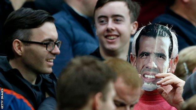 Fan wears Carlos Tevez mask (right)