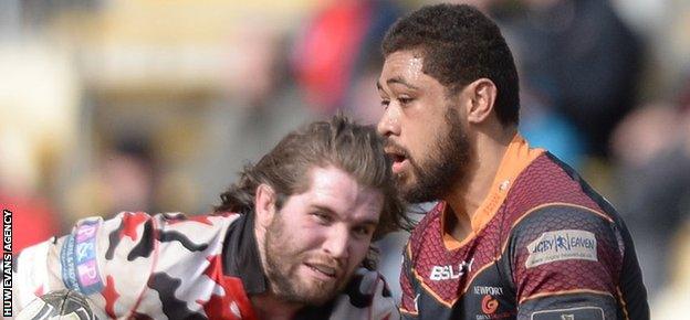 Dragons' Taulupe Faletau gets the ball away