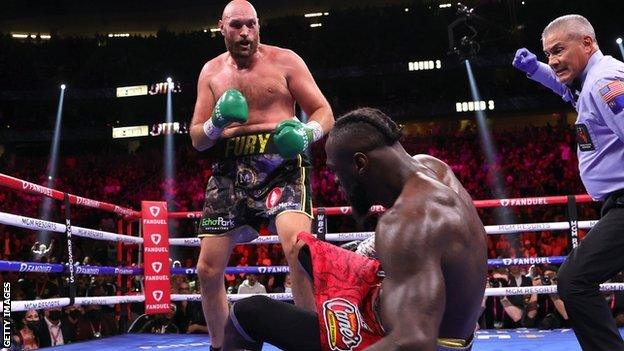 Tyson Fury knocks down Deontay Wilder