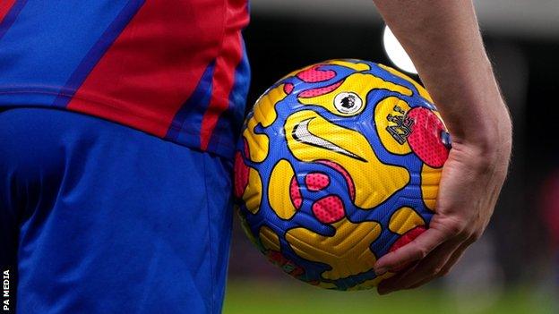 Footballer holding a football