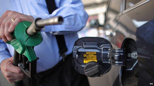 Man filling up his car at petrol station in West Lothian