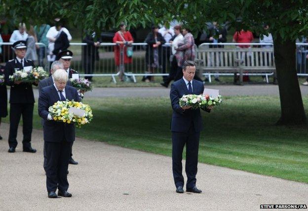 London Mayor Boris Johnson (left)and British Prime Minister David Cameron carry wreaths at the July 7 memorial in Hyde Park, London