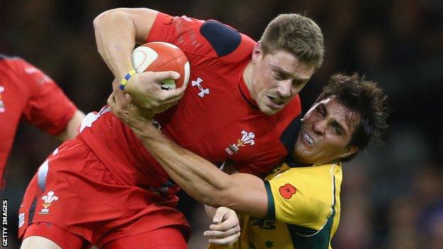 Rhys Priestland of Wales is tackled by Nick Phipps of Australia in November 2014