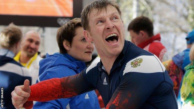 Bobsledder Aleksandr Zubkov celebrates winning a gold medal at Sochi 2014