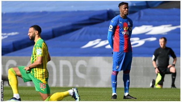 Wilfried Zaha stands at kick-off