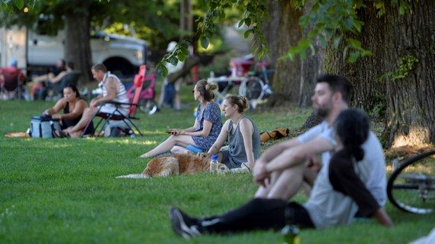 People sitting in the shade outdoors