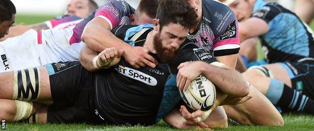 Greg Peterson manages to get the ball over the line to score a try for Glasgow Warriors