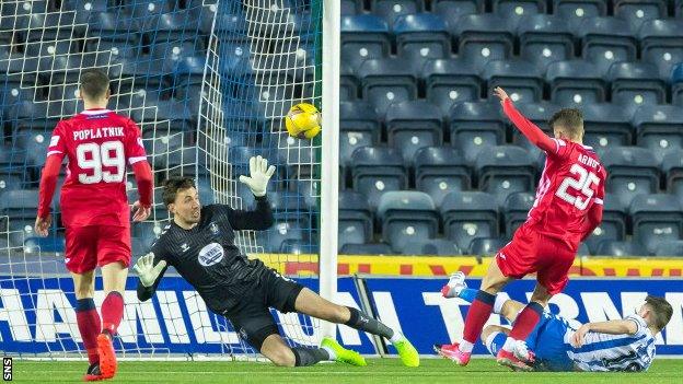 Rovers midfielder Aaron Arnott and Kilmarnock defender Calum Waters bundle the ball home