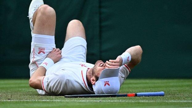 Andy Murray slips on the Wimbledon grass