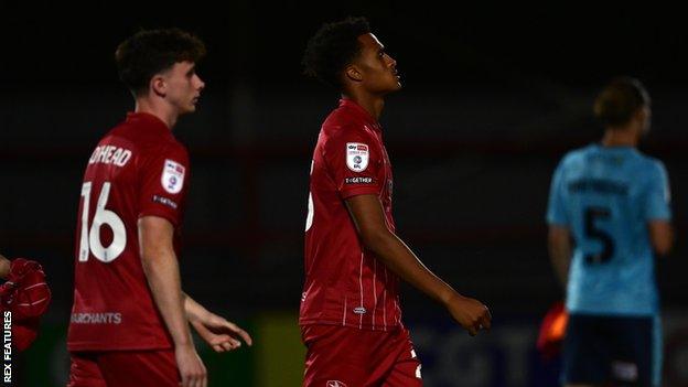 Cheltenham players look dejected during match with Exeter City