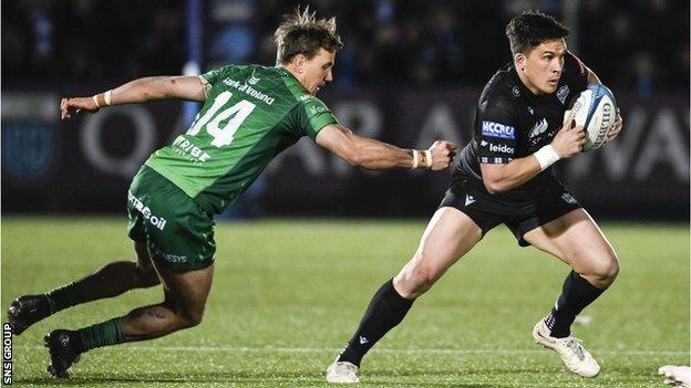 Warriors' Sam Johnson escapes the grasp of Connacht's John Porch during a BKT United Rugby Championship match between Glasgow Warriors and Connacht at Scotstoun Stadium