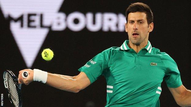 Novak Djokovic hits a return against Jeremy Chardy at the Australian Open