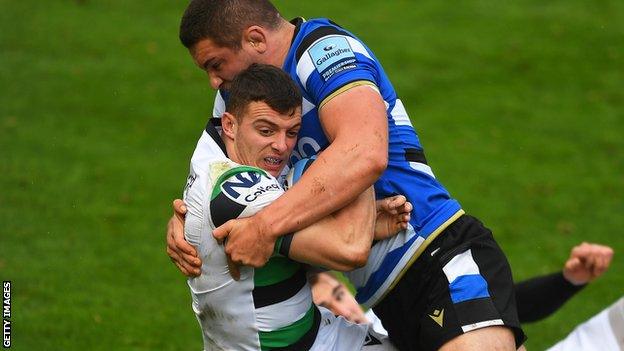 Charlie Ewels (right) tackles Adam Radwan