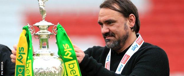 Norwich head coach Daniel Farke picks up the Championship trophy