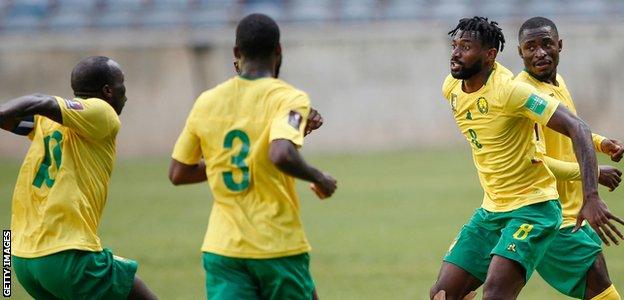 Cameroon midfielder Andre-Frank Zambo Anguissa (second right) celebrates his goal against Malawi