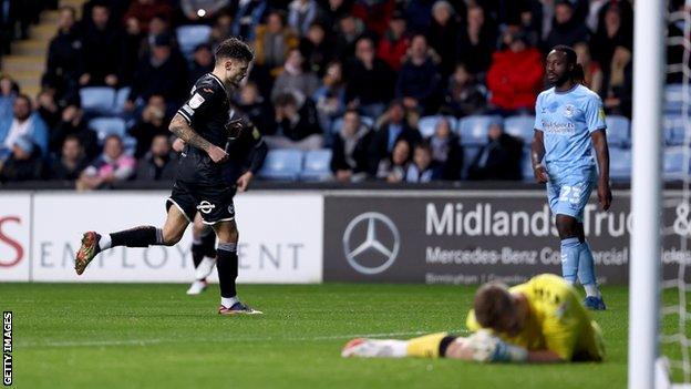 Jamie Paterson runs away to celebrate after putting Swansea in front with his sixth goal of the season