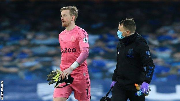 Everton keeper Jordan Pickford leaves the field after sustaining an injury against Burnley