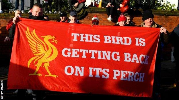 Liverpool fans celebrate with a banner that says 'This bird is getting back on its perch'