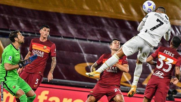 Cristiano Ronaldo rises for a header to score and earn Juventus a draw